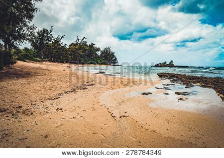 Dust And Dirt On The Sand Of This Hawaiian Beach, With Cloudy Sky. Us