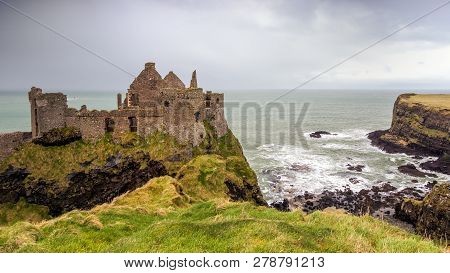 View On The Coastal Dunluce Castle Ruins In Northern Ireland