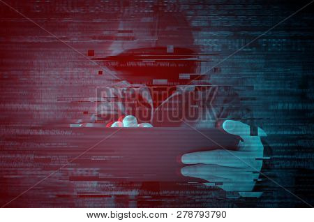 Cyber Security. Hooded Computer Hacker Using Tablet Computer With Glith Effect.