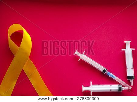 Golden Ribbon And Medicine. Concept - A Symbol Of Childhood Cancer, Pediatric Oncology