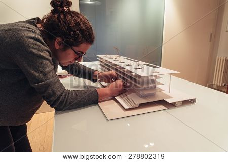 Female Architect Working On Architecture Model On Table