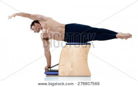 one caucasian man exercising fitness pilates exercices isolated on white background