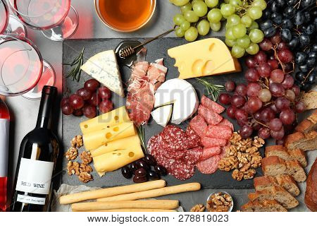 Flat Lay Composition With Wine And Snacks On Grey Background