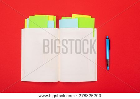 Noteboook And Pen Isolated On Red Background