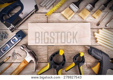 Set Of Construction Tools On A White Wooden Plank, Directly Above. Copy Space For Your Text.