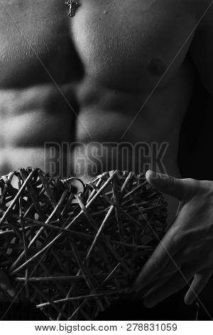 Athletes Body In Close Up, Hand Holding Big Rattan Heart