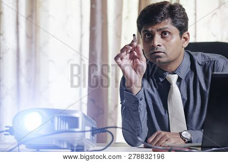 Business Executive Using Projetor When Showing Presentation And Explaining Details