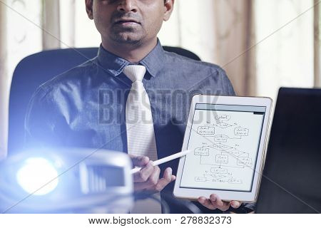 Software Developer Showing Scheme On Scren Of Table Computer