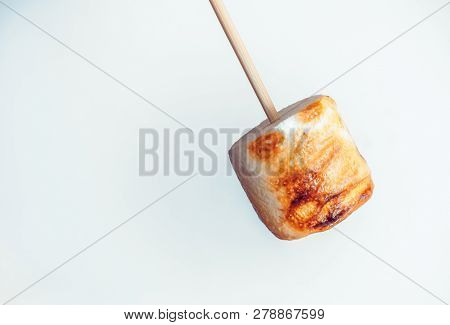 Roasted Marshmallows On A Skewer On White Background