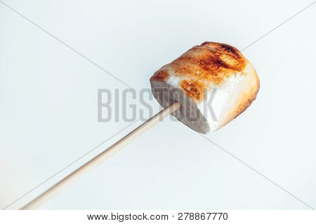 Roasted Marshmallows On A Skewer On White Background