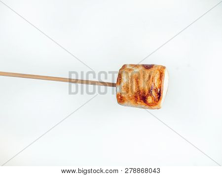 Roasted Marshmallows On A Skewer On White Background