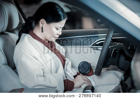 Businesswoman Behind The Wheel Feeling Inattentive After Spilling Coffee
