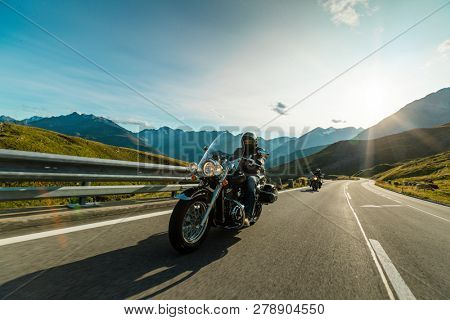 Motorcycle driver riding in Alpine highway, Hochalpenstrasse, Austria, central Europe.