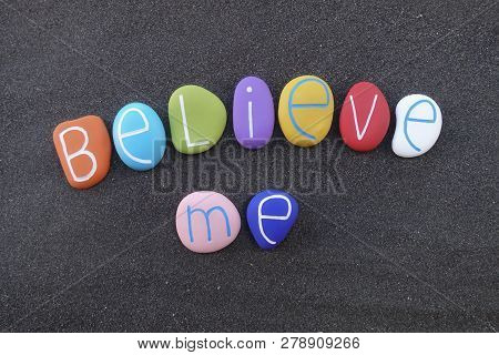 Believe Me, Motivational Words Composed With Colored Stones Over Black Sand