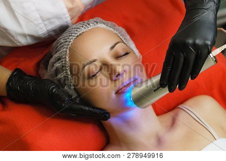 Hardware Cosmetology. Beautician Makes Ultrasonic Skin Tightening Client. Skin Pore Cleansing. Anti-