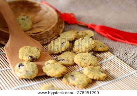 Chinese New Year Homemade Cookies With Cranberry On Bamboo Stick , On Sackcloth Background
