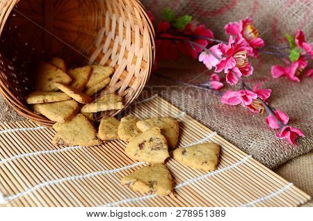Chinese New Year Homemade Cookies With Sesame Seeds, On Bamboo Stick , On Sackcloth Background