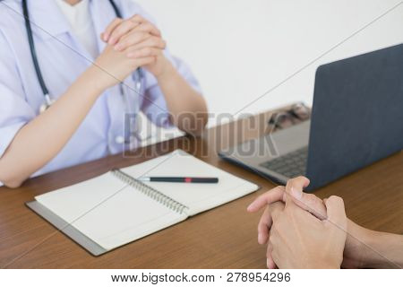 Doctor Physician Consulting With Male Patients In Hospital Exam Room. Men's Health Concept