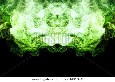 Dense Multicolored Smoke Of    Green Colors In The Form Of A Skull, Monster, Dragon On A Black Isola