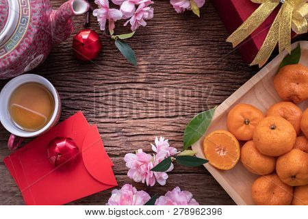 Orange Fruit, Pink Cherry Blossom And Chinese New Year Composition Set On Wood Table, Chinese New Ye