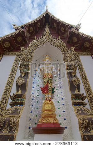 The White Standing Buddha Statue With Four Heads And Four Arms In The Wat Saen Muang Ma Luang In Chi