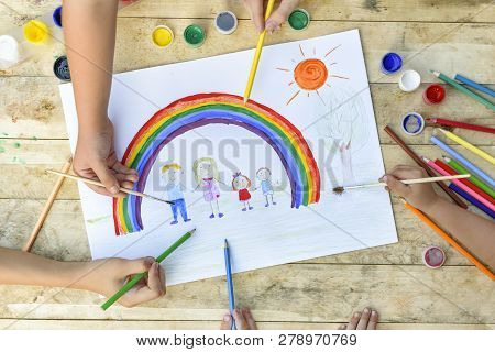 Happy Family Concept. Co-creation. Children Hands Draw On A Sheet Of Paper: Father, Mother, Boy And 