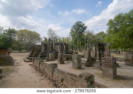 Seated Buddha Statue Surrounded By A Brick Wall In Sukhothai Historical Park