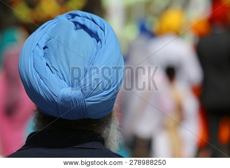 Senior Bearded Sikh Religion Man With Blue Turbaned During The Religious Ceremony In The Streets Of 