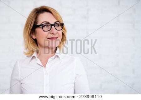 Business Idea Concept - Portrait Of Thoughtful Cheerful Mature Business Woman In Eyeglasses Posing O