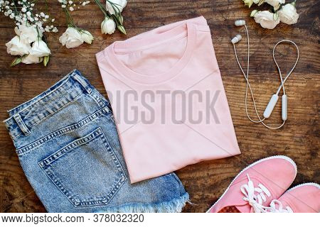 Mockup Of A Folded T-shirt Placed Surrounded By Trendy Aaccessories And Flowers Flat Lay