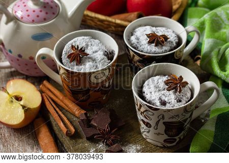 Quick Autumn Dessert. Autumn Apple Pie Mugcake With Red Apples And Spices On A Rustic Background.