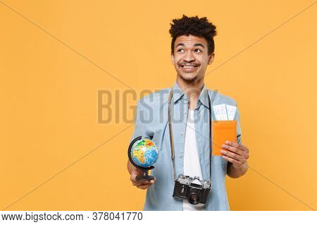 Smiling Young African American Guy In Blue Shirt With Photo Camera Traveling Abroad Isolated On Yell