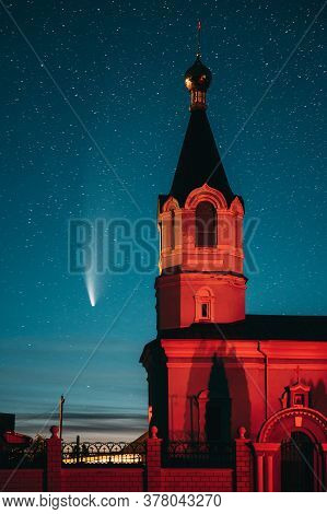 Korma Village, Dobrush District, Belarus. Comet Neowise C2020f3 In Night Starry Sky And St. John The