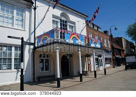 TENTERDEN, ENGLAND - MAY 27, 2020: Tenterden Town Hall decorated with rainbow banners in support of key workers during the Corona Virus pandemic. The historic building dates from 1790.