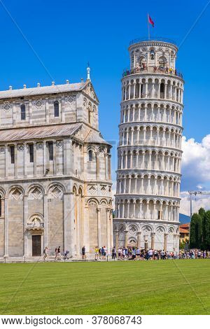 Pisa, Italy - August 14, 2019: View Of The Pisa Cathedral With The Leaning Tower Of Pisa In Piazza D