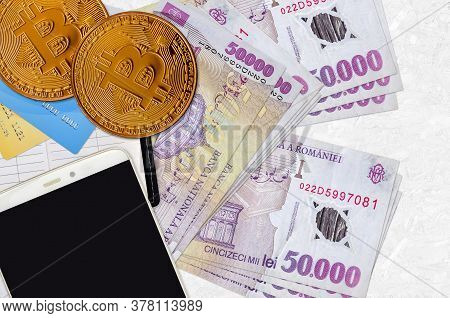 50000 Romanian Leu Bills And Golden Bitcoins With Smartphone And Credit Cards. Cryptocurrency Invest