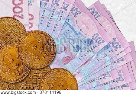 200 Ukrainian Hryvnias Bills And Golden Bitcoins. Cryptocurrency Investment Concept. Crypto Mining O