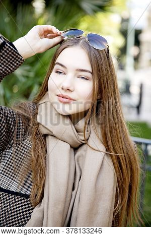 Young Long Hair Woman Model Of Clothes In The Garden In Spring Posing
