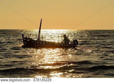 Bar, Montenegro - September 10, 2011: Fisherman In Boat At Sunset