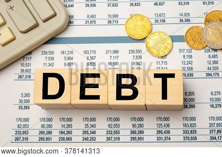 Wooden Blocks With The Word Debt. Reduction Or Restructuring Of Debt. Refusal To Pay Debts Or Loans 