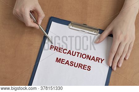 Female Doctor Holds Paper Board With Text Words Precautionary Measures