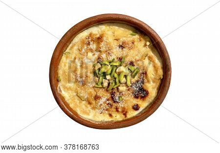 Traditional Arabic, Eastern Dessert Om Ali. Top View. Egyptian Bread Pudding In A Brown Bowl Isolate