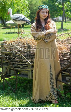 Armenian Young Woman In Traditional Clothes In The Forest