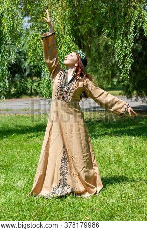 Armenian Young Woman In Traditional Clothes Dancing In The Forest