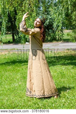 Armenian Young Woman In Traditional Clothes Dancing In The Forest