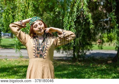 Armenian Young Woman In Traditional Clothes In The Forest