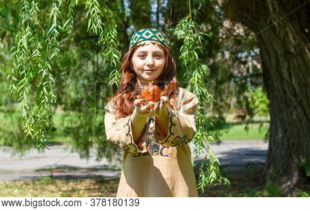 Armenian Young Woman In Traditional Clothes In The Forest With Pomegranate