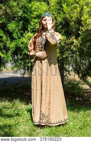 Armenian Young Woman In Traditional Clothes In The Forest