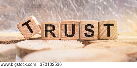 Wooden Blocks With The Word Trust. Business And Finance Concept.