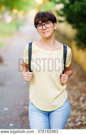 Beautiful Middle-aged Woman Walking Down The Street